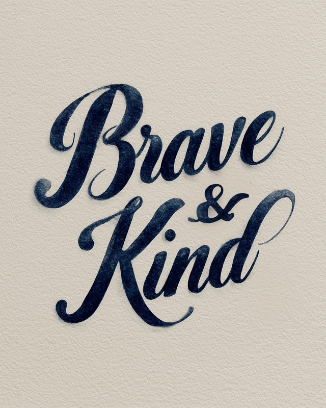 Brave and Kind nursery calligraphy poster with sweeping navy script on cream textured paper